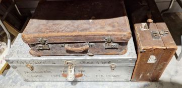 Two vintage suitcases including a brown leather example and an aluminium shipping trunk with leather