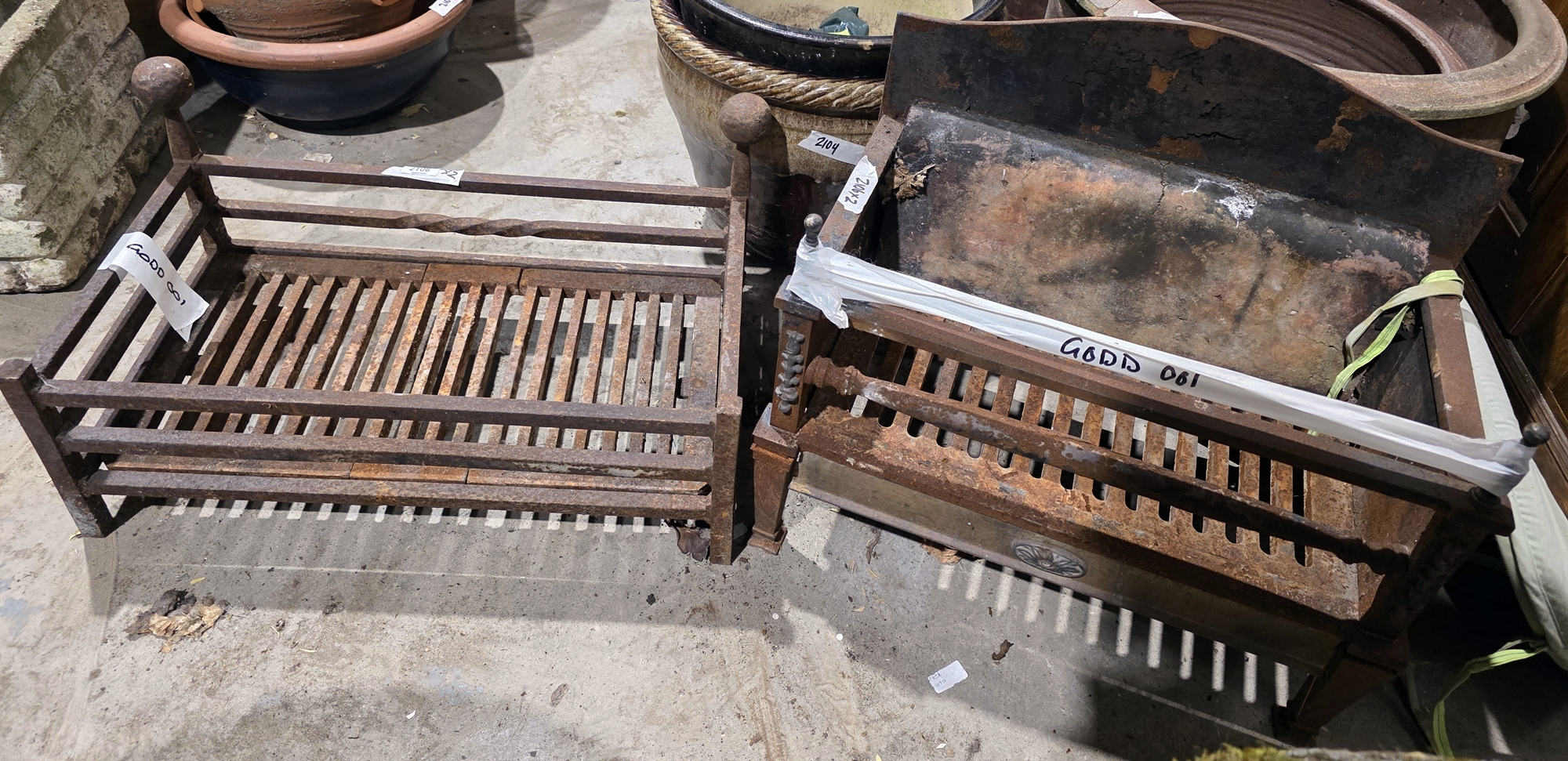Two cast iron firegrates, one with built in fireback, largest 51cm wide x 32cm deep x 19cm high (2)