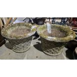 Pair of large reconstituted stone planters of flared form with rolled rims and moulded trellis