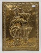 A brass repousse decorated wall hanging/fire screen depicting a tall masted ship 50cm x 37.5cm