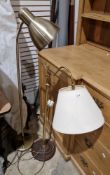 Two contemporary floor lamps, one in a brushed brass effect and the other with gilt metal scroll