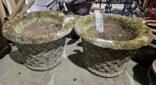 Pair of large reconstituted stone planters of flared form with rolled rims and moulded trellis