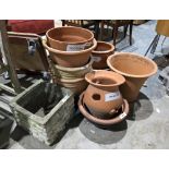 Quantity of mainly terracotta plant pots of varying shapes and sizes, including a herb planter