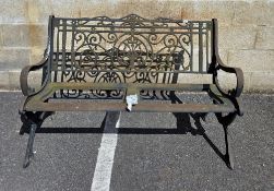 Cast iron garden bench, the pierced back with scrolling and floral decoration, the ends with