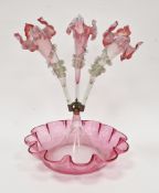 Victorian cranberry glass three-trumpet epergne, with applied rigaree to trumpets, all raised on a