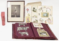 Victorian Geoffrey's scrapbook containing burgundy fabric pages partially filled with Victorian,