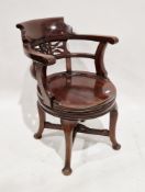 Edwardian mahogany swivel tub elbow chair with pierced splat, circular saddle seat on four