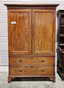 Early 19th century mahogany wardrobe, the moulded cornice over two panel doors opening to a