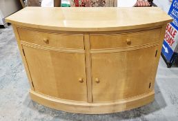 A contemporary anegre veneered side cabinet of bow fronted form, comprising two compartmentalised