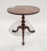 Early 19th century mahogany low table, the circular tilt-top with raised rim, on a turned ringed