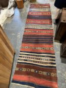 Large red ground runner with multiple geometric stripes, 330cm x 94cm