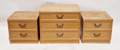 G-Plan pair of teak bedside chests, each having two drawers with gilt metal drop loop handles,