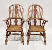 Pair of 19th century oak and elm windsor elbow chairs, the hooped back with pierced splats and