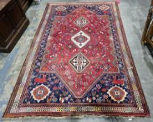 Large Eastern red ground rug with three octagonal medallions on geometric shape pattern field,