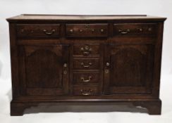George III oak dresser base having three frieze drawers over four central drawers flanked either