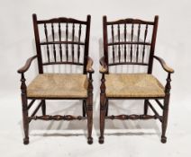 Pair of ash Lancashire style elbow chairs with spindle backs and rush seats, on turned legs, 104cm