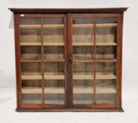 19th century stained pine hanging glazed cabinet, the two glazed doors opening to five narrow