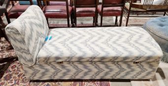 Early 20th century ottoman daybed with box base, upholstered in a blue and cream fabric, on