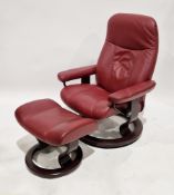 Ekornes stressless reclining armchair and matching footstool, red burgundy upholstery, on rosewood