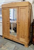 19th century pine triple wardrobe having a central mirrored door flanked either side by panel