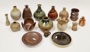 Six various studio pottery bottle-shaped vases in various shades of green, brown and beige, Milbrook