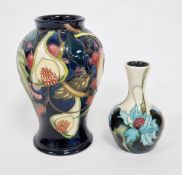 Two Moorcroft vases comprising a Queens Choice pattern vase by Emma Bossons decorated with tubelined