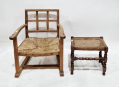 In the manner of Heal's of London, Arts and Crafts oak fireside elbow chair with lattice back and