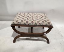19th century mahogany stool of rectangular form, having a floral needlework upholstered seat, on
