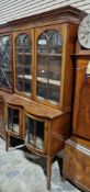 Edwardian mahogany display cabinet, the upper section with two arched glazed doors opening to two