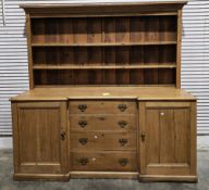 19th century pine dresser base of inverted breakfront form, comprising a central bank of four