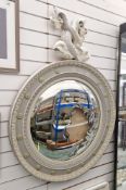 Large convex mirror in the Regency manner, the cresting carved in the form of two entwined dolphins,