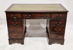 20th century mahogany effect twin pedestal desk in the George III manner, the top with green leather