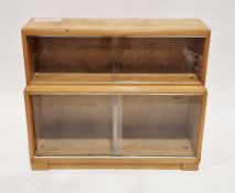 Mid-century Minty teak library bookcase comprising two sections, each with two glass sliding