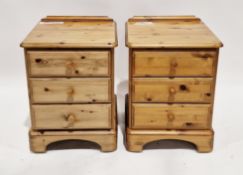 Pair of modern pine bedside cabinets, each comprising three short drawers with pine knob handles, on