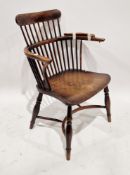 19th century elm and yew wood comb back elbow chair on turned baluster legs united by a crinoline