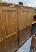 Modern pale oak bedroom suite comprising two wardrobes, each with two panel doors opening to a
