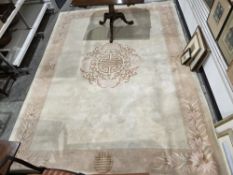 Large cream ground Chinese superwash carpet with central floral motif, single floral border, 368cm x