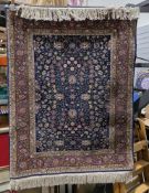 Eastern midnight blue ground rug with floral field, multiple herati and floral borders, 132cm x