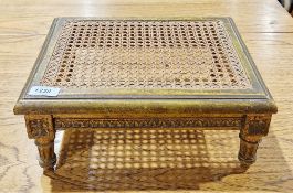 Giltwood footstool of rectangular form with cane top, on turned reeded legs, 13cm high x 33cm wide x