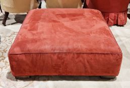 Modern Italian square ottoman stool upholstered in a red suede-type fabric, on square block feet,