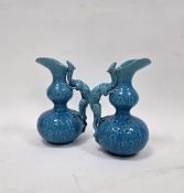 Pair of Burmantofts turquoise ground dragon moulded double-gourd shaped jugs, late 19th century,