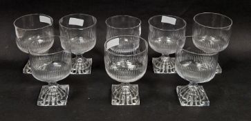 Eight Regency cut-glass rummers, each on moulded lemon squeezer foot, the bowl cut with flutes, 12.4