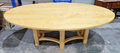 A contemporary dining or conference table of oval form, the top having an anegre veneer, on six
