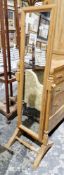 Modern pine framed cheval mirror of rectangular form on turned supports, 152cm high x 45cm wide x