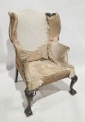 Walnut framed wing back armchair in the George II manner, acanthus leaf capped carved cabriole front