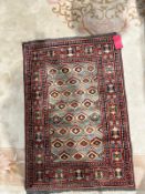 Eastern blue ground rug with eight rows of geometric medallions, multiple geometric borders, 123cm x