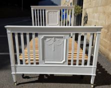 Double bedstead comprising a white painted slatted headboard and footboard, pine slatted base, on