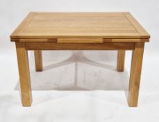 Modern pale oak drawer leaf table of rectangular form on square legs, 77cm high x 120cm long (