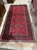 Afghan red ground rug with five elephant foot guls, on geometric pattern field, single geometric