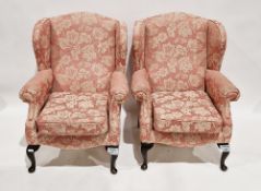 Pair of wing back armchairs by Jade Holdings, upholstered in a pink fabric with cream floral